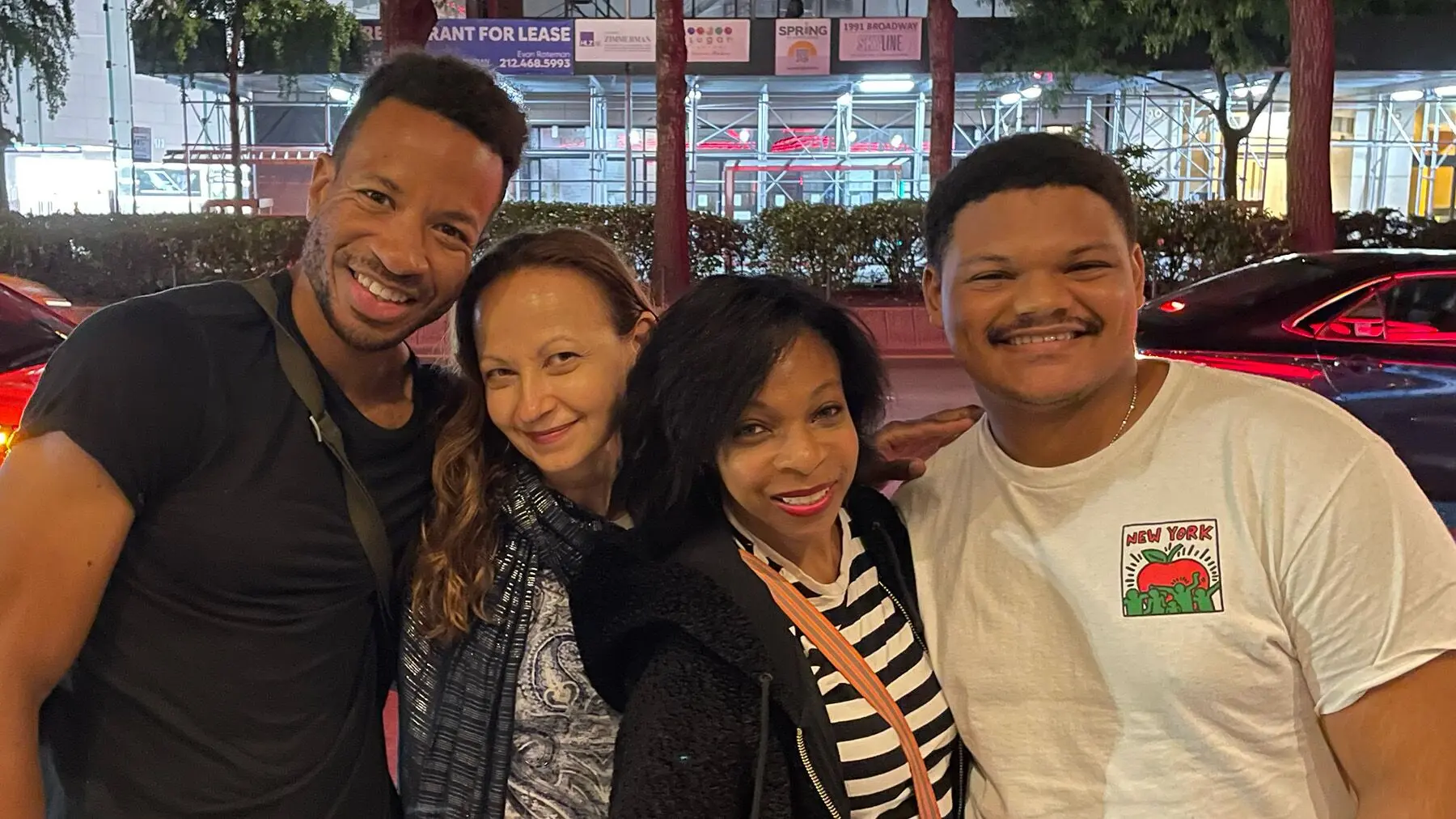 Full Implant Choice patient laughing with friends and family, showing her new smile